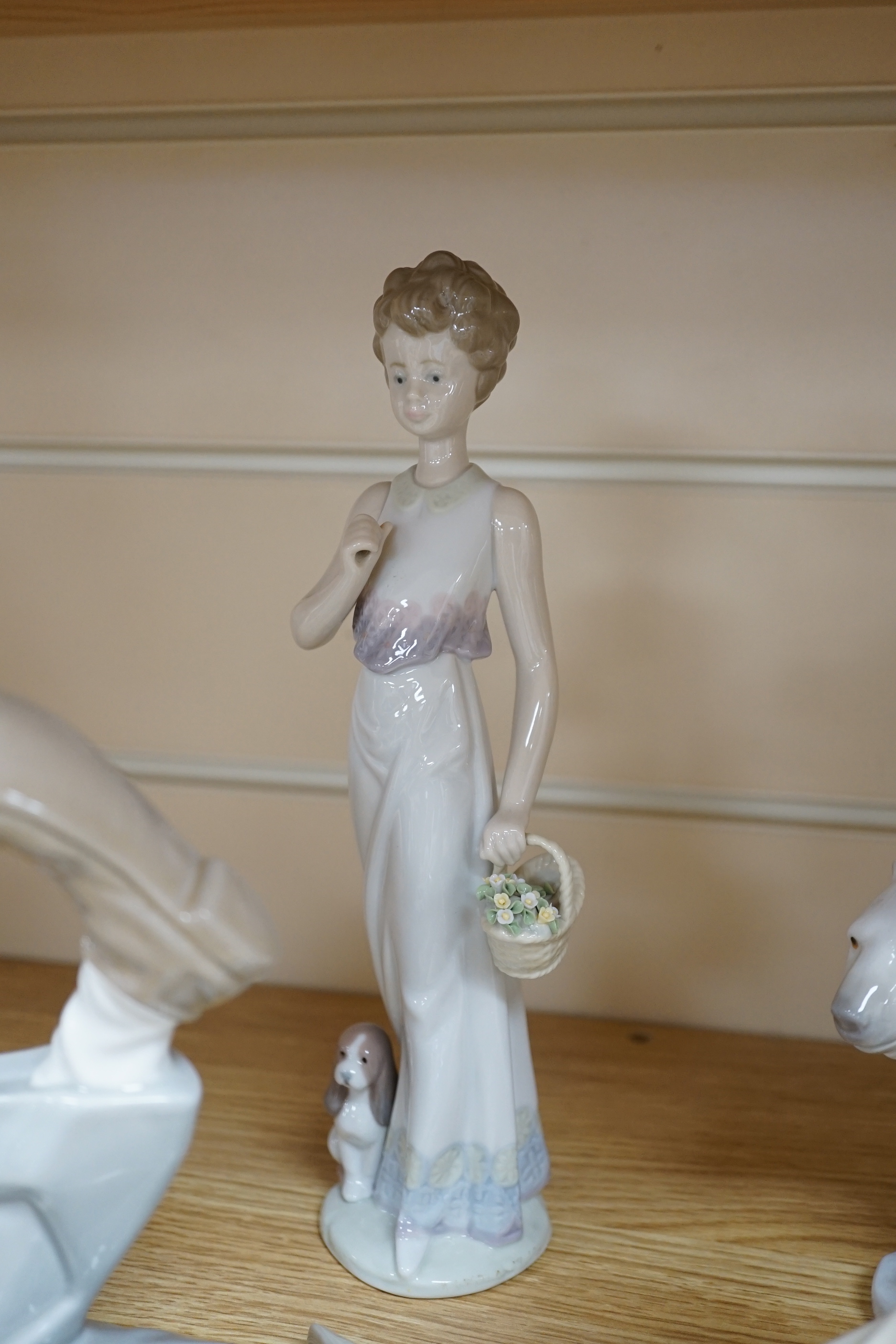 Seven Lladro figures including a clown together with three Lladro bells, the clown 37cm wide